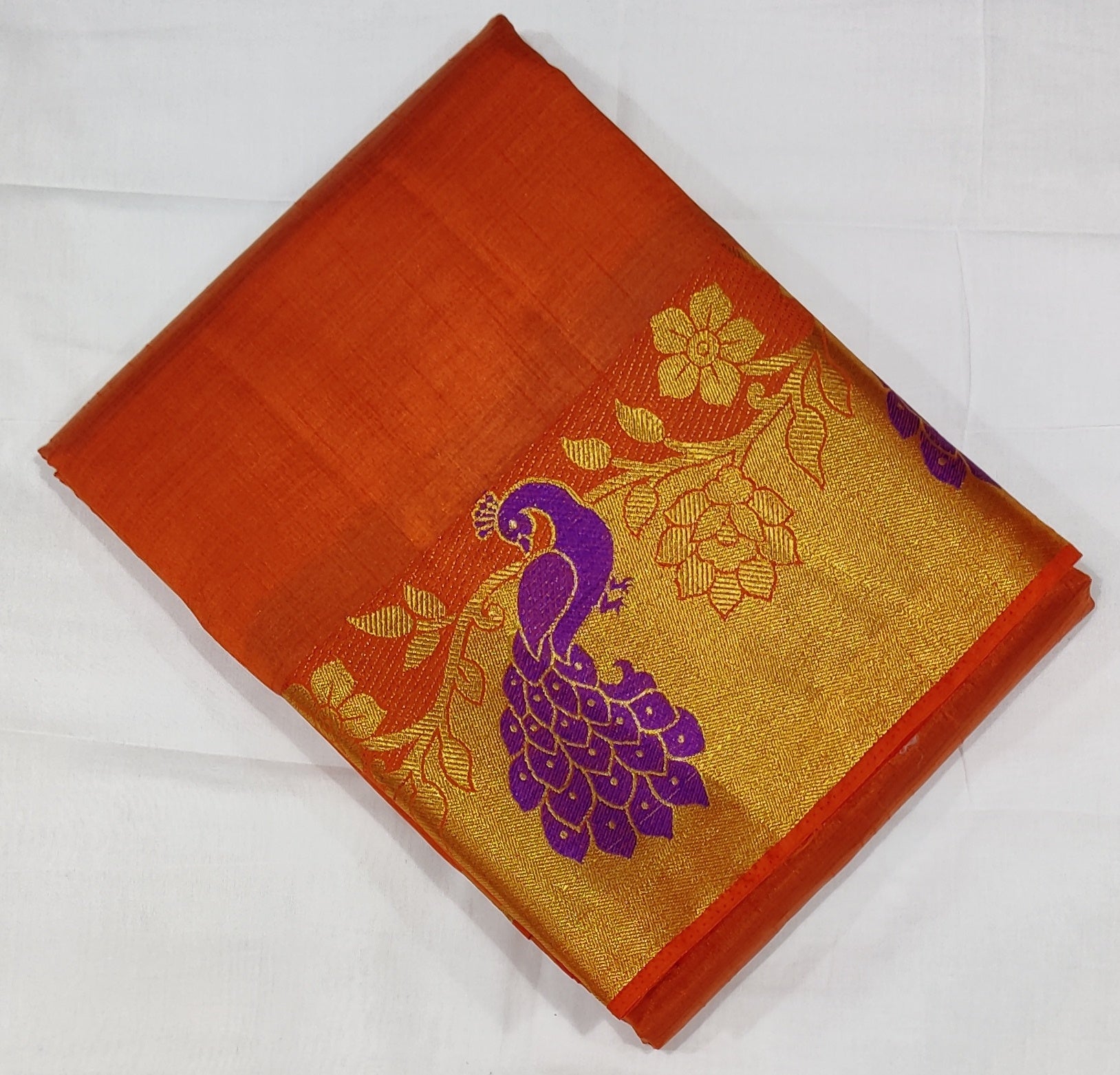 33372 Semi Raw Silk Saree with Big Peacock embossed Zari Border and Orange Body Color