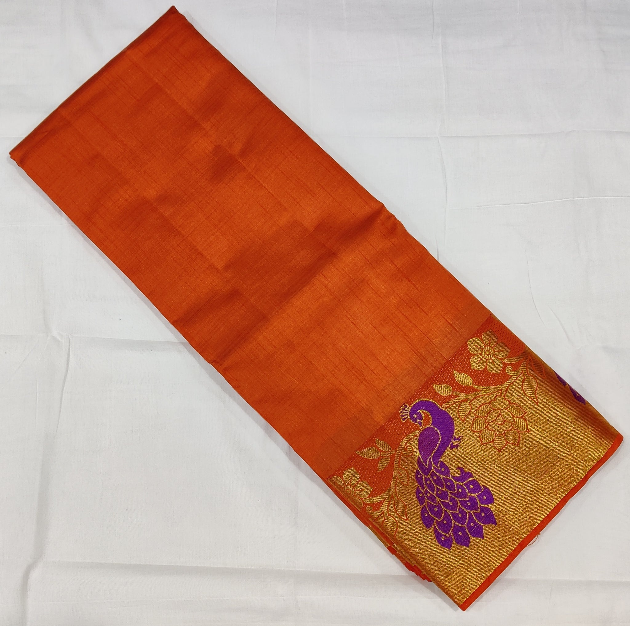 33372 Semi Raw Silk Saree with Big Peacock embossed Zari Border and Orange Body Color
